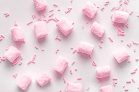 Flat lay of beautiful marshmallows and sprinkles, soft pink backgroundの写真素材