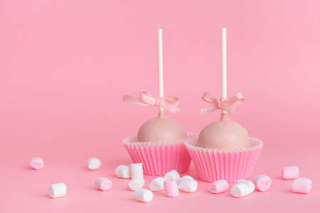 couple festive icing cake pops and marshmallows over pink background, concept of Valentines dayの写真素材