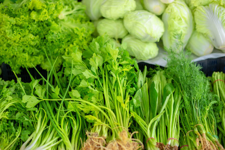 Showcase with fresh greens and vegetables, concept healthy eating, south east farmer market