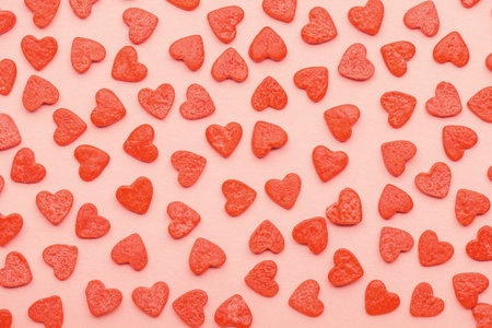 Sweet sprinkles of heart shapes over pink