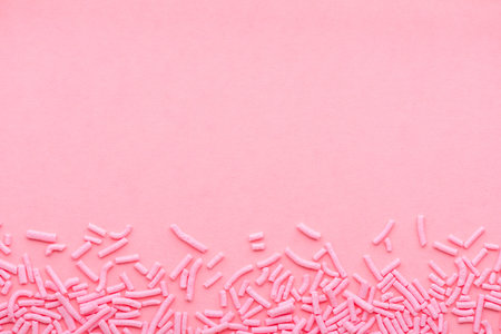 greeting background of soft sprinkles over pink, festive invitation for Valentines day, birthday,...