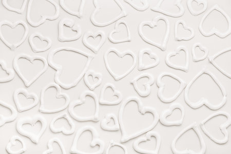 sweet meringue kiss cookies of heart shapes over white background, concept of St. Valentine's Day,...