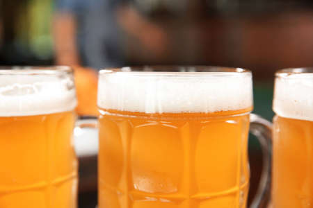 Glass cup of fresh beer on blurred background, closeupの写真素材