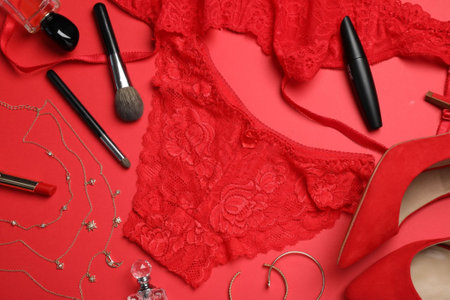 Composition with lacy women lingerie, cosmetics and accessories on red background.view from aboveの写真素材