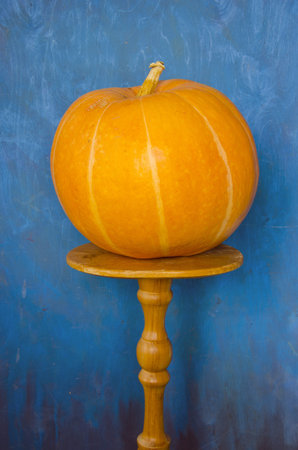 orange pumpkin on the table and blue backgroundの写真素材