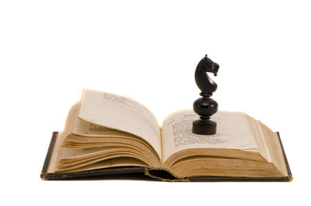 isolated on white vintage book and chess knightの写真素材