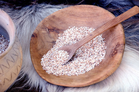 ecological groats in the wooden plate and spoon