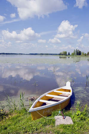 landscape with yellow boat in the summer lakeのeditorial素材