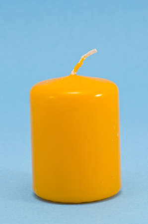 yellow new candle on azure backgroundの写真素材