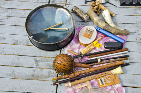 many various original musical instruments on wooden background