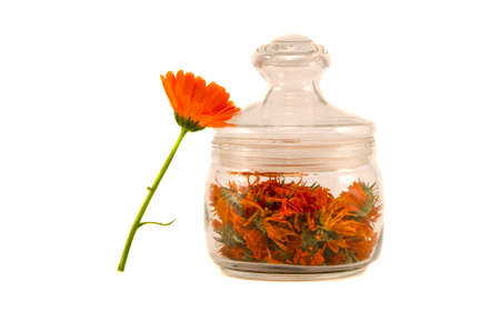 glass jar with calendula dry flowers isolated on whiteの写真素材