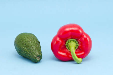 fresh green avocado and red pepper on azure backgroundの写真素材