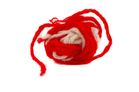 red and white needlecraft thread ball isolated on white backgroundの写真素材