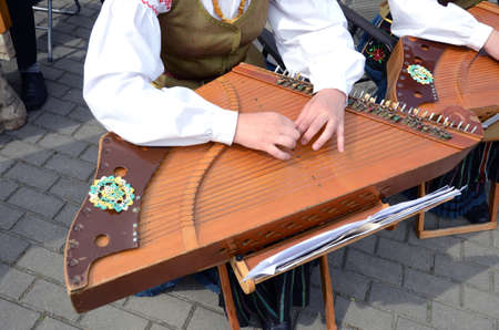 girl playing with retro  ethnographic string musical instrumentの写真素材