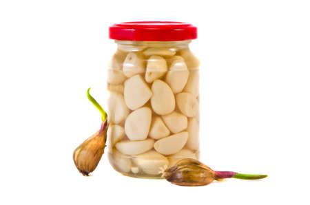 pickled garlic in glass jar and sprin garlic sprouts isolated on whiteの写真素材