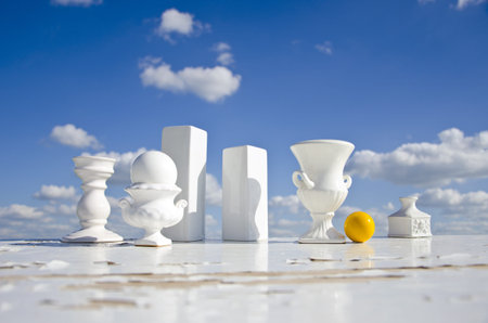 still-life in space with white vases and yellow billiards ball