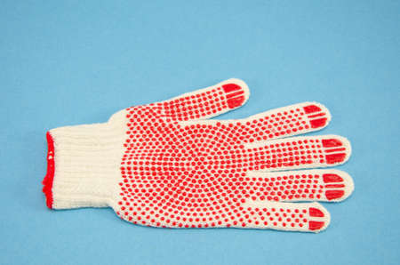 one new protective glove on azure backgroundの写真素材