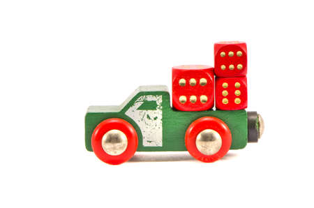 old truck toy with three red dice isolated on white backgroundの写真素材