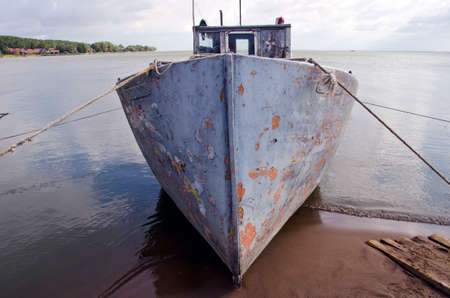 old fishing boat near coast in seaの写真素材