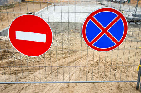 two road signs on street repair fenceの写真素材