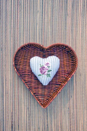 decorative handicraft cloth heart in wicker basketの写真素材
