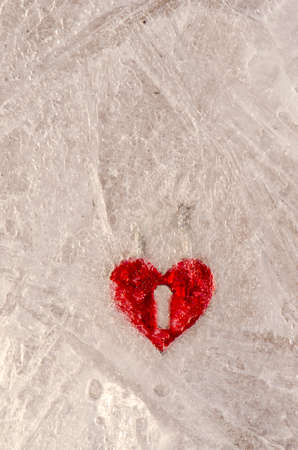 red heart form frozen in winter ice. Love end conceptの写真素材