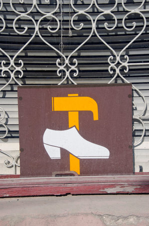 shop window with vintage shoe repair shop signの写真素材