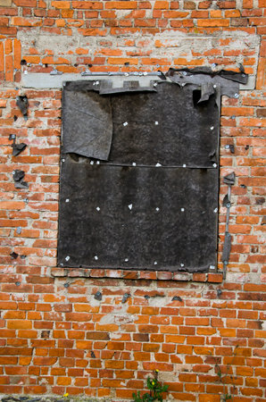 old brick wall with closed window hole 