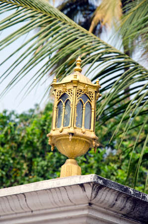 decorative ornate golden lamp in asia gardenの写真素材