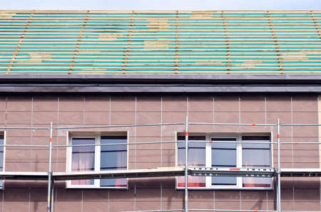 roof repair construction and scaffold construction near windowsの写真素材