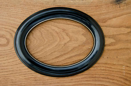 oval frame on oak wood plank backgroundの写真素材