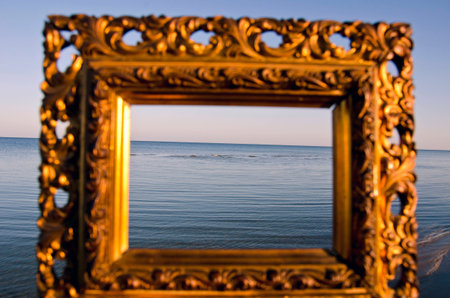 vintage golden picture frame and summer sea landscape