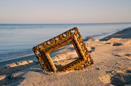 vintage golden picture frame on sea resort beach in sunrise light