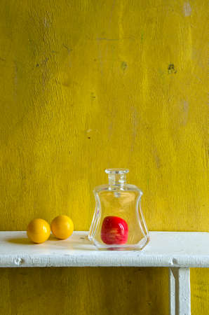 billiard balls and glass bottle on white wooden shelf. home decorationの写真素材