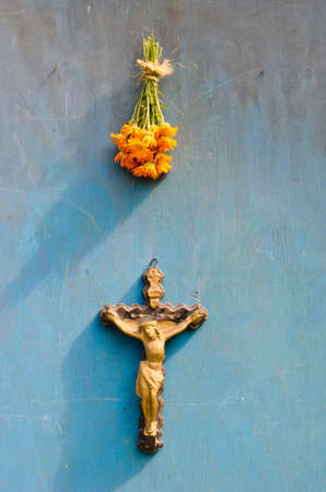Suffering of Jesus Christ crucifixion and marigold medical flowers on old blue wooden wallの写真素材