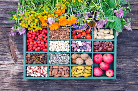 various medical herbs, vegetarian healthy fruits, seeds and dried food ingredient  in wooden boxの写真素材