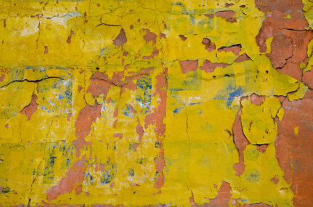 old yellow cracked painted wall background and texture