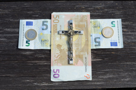 euro money cross and metal crucifixion with Jesus conceptの写真素材