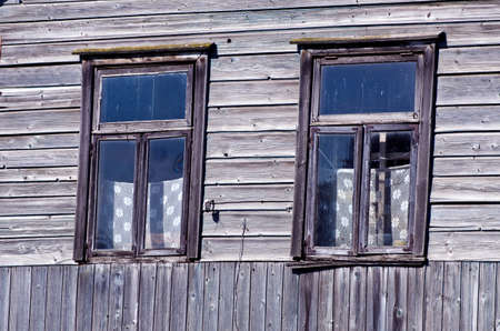 two old windows on farm wooden wallの写真素材