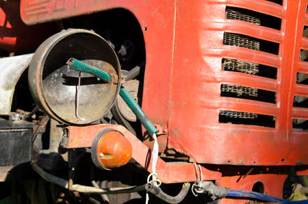 old vintage used red tractor fragment with lampの写真素材
