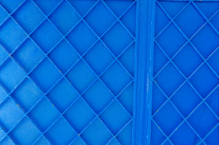 Background of blue painted metal partitioned in geometrical fashionの写真素材