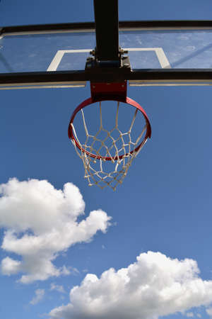 Basketball stand with a hoop outdoors against blue skyの写真素材