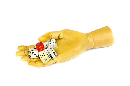 Wooden artist manikin hand with colorful bones dice of game,isolated on whiteの写真素材
