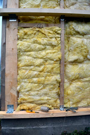 house wall with insulation material rockwool fragment and toolsの写真素材