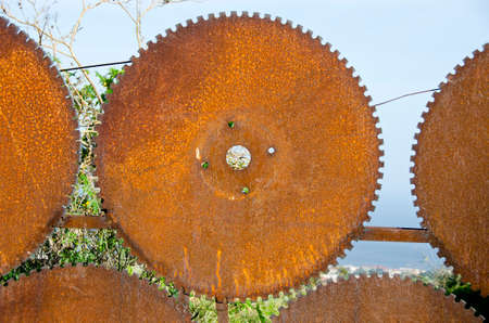 Fence gate made from old rusty circle blade toolsの写真素材