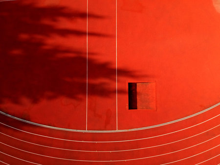 Abstract red stadium background with athlethic tracks lines, aerial view