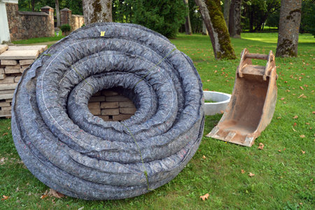 Roll stack drain drainage pipe with protective cover in city park