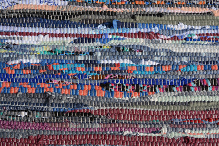 Colored knitted homemade carpet background and texture