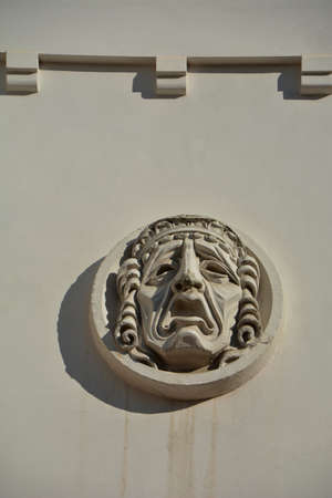 Plaster mask symbol on old wall of the theaterの写真素材