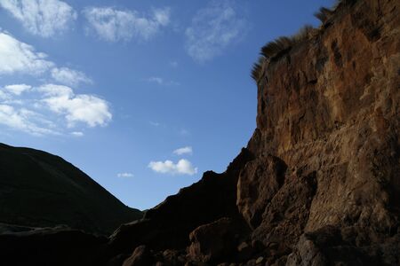 The cliff face and sky at Hamilton gap beach in Auckland, New Zealand.の写真素材